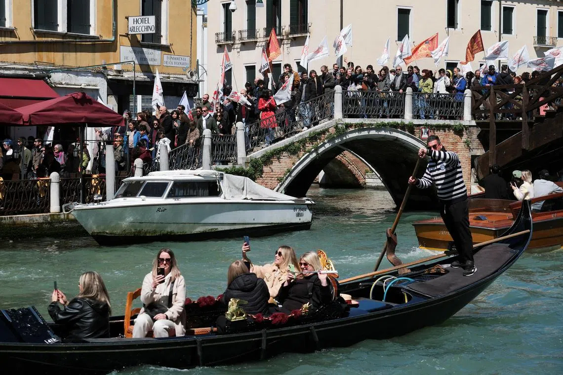 People protest against the introduction of the registration and tourist fee to visit the city of Venice for day trippers introduced by Venice municipality in a move to preserve the lagoon city often crammed with tourists in Venice.