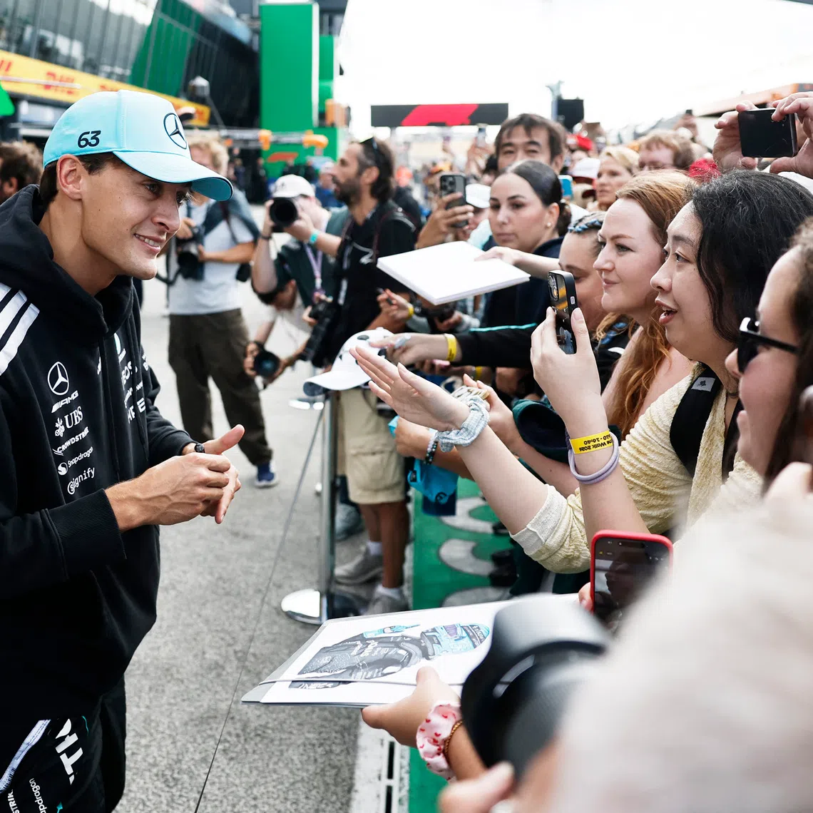 Formula One F1 - Dutch Grand Prix - Circuit Zandvoort, Zandvoort, Netherlands - August 20, 2026 Mercedes' George Russell with fans in the pitlane ahead of the Dutch Grand Prix REUTERS/Benoit Tessier