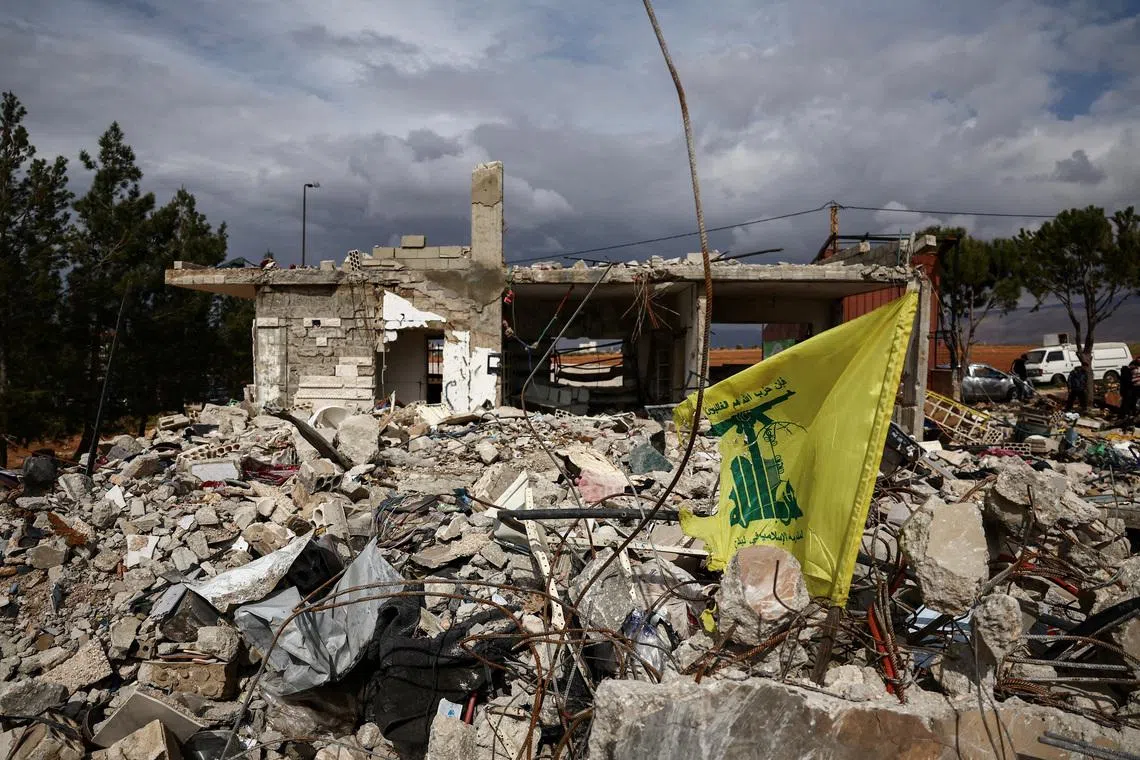 FILE PHOTO: A Hezbollah flag is placed in front of a house destroyed by an Israeli strike, following an escalation between Hezbollah and Israel, amid the U.S.-Israeli conflict with Iran, during a media tour in Chaat, Lebanon, March 23, 2026. REUTERS/Yara Nardi/File Photo