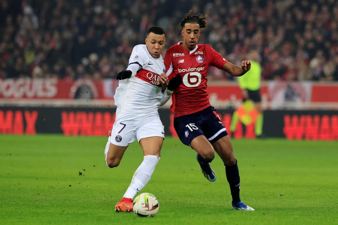 FILE PHOTO: Soccer Football - Ligue 1 - Lille v Paris St Germain - Stade Pierre-Mauroy, Villeneuve-d'Ascq, France - December 17, 2023 Paris St Germain's Kylian Mbappe in action with Lille's Leny Yoro REUTERS/Pascal Rossignol/File Photo