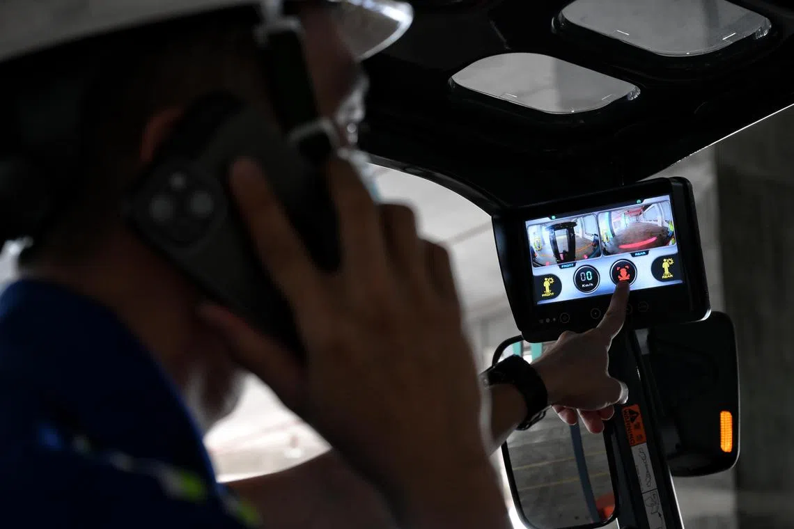 An artificial intelligence system on an enhanced forklift detects when operators use their handphones.