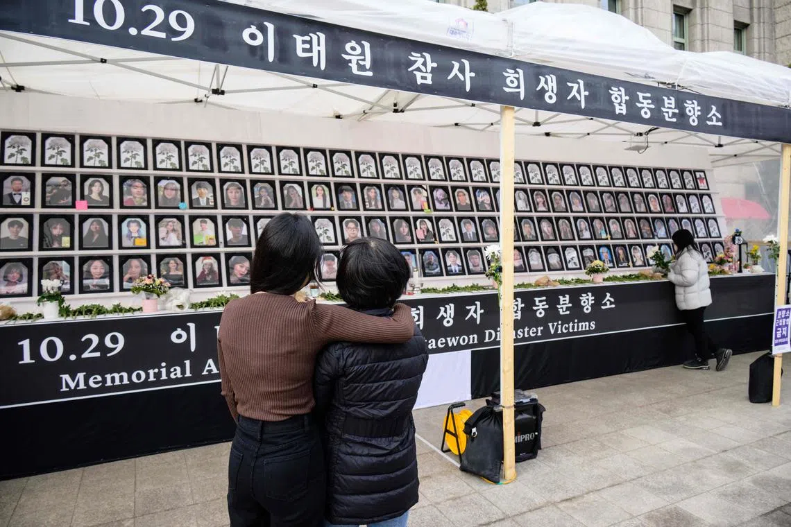 Ms Lee Ga-young (L), whose 24-year-old brother Lee Ji-han was killed in a Halloween crowd crush in the popular Itaewon district in October last year, hugging her mother Madam Cho Mi-eun as they visit a public memorial in Seoul for those who died during the disaster on March 8.