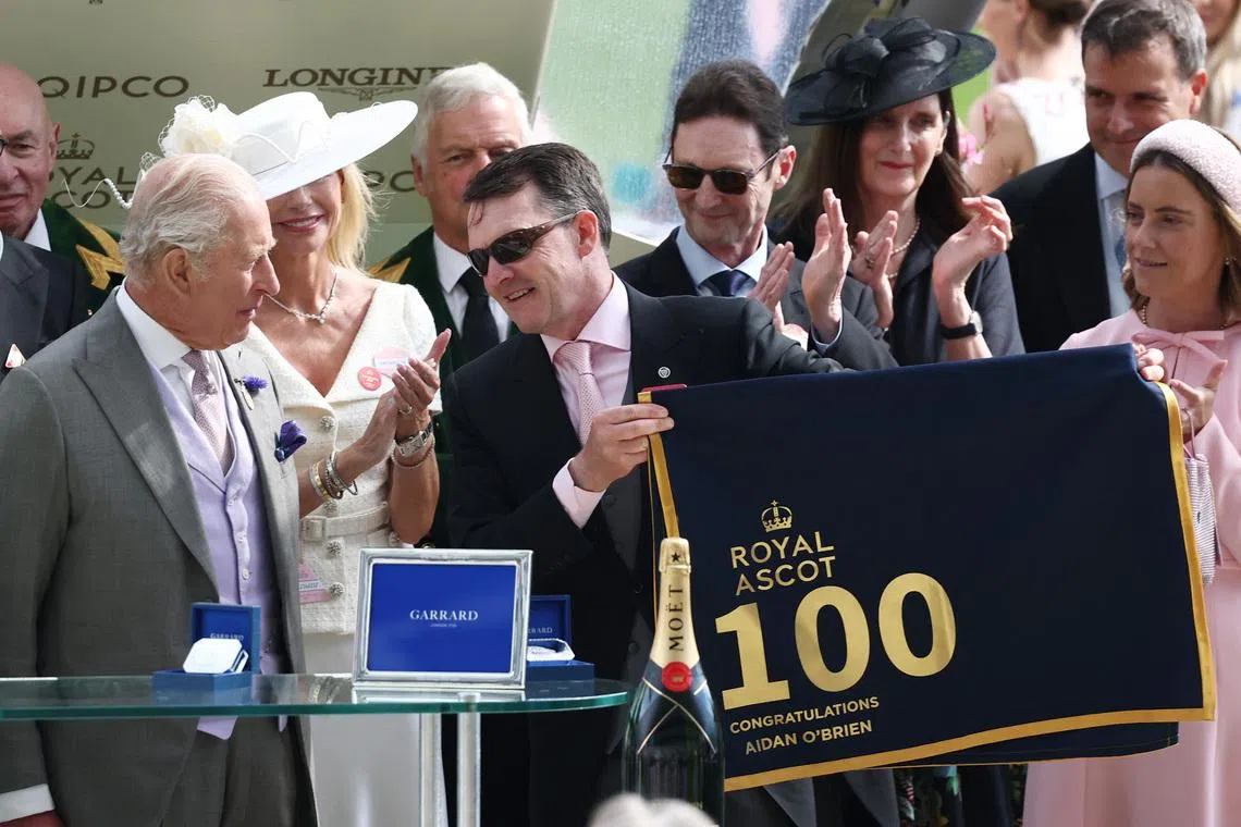 Horse Racing - Royal Ascot 2026 - Ascot Racecourse, Ascot, Britain - June 18, 2026 Aidan O'Brien, trainer of Scandinavia is presented with a racing tack to commemorate 100 Ascot race wins by Britain's King Charles after winning the 16.15 Gold Cup REUTERS/Toby Melville