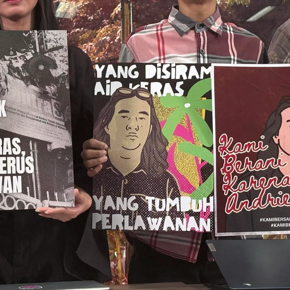 Activists from the Advocacy Team for Democracy hold up posters in support of Mr Andrie Yunus, the victim of the acid attack, at a press conference in Menteng, Central Jakarta, on March 16.