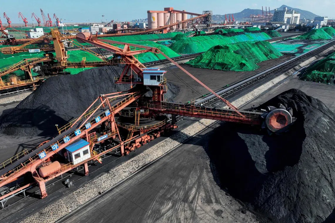 Coal unloaded from cargo ships is seen at the coal terminal of Lianyungang Port in Lianyungang, in China's eastern Jiangsu province on January 22, 2024. (Photo by AFP) / China OUT