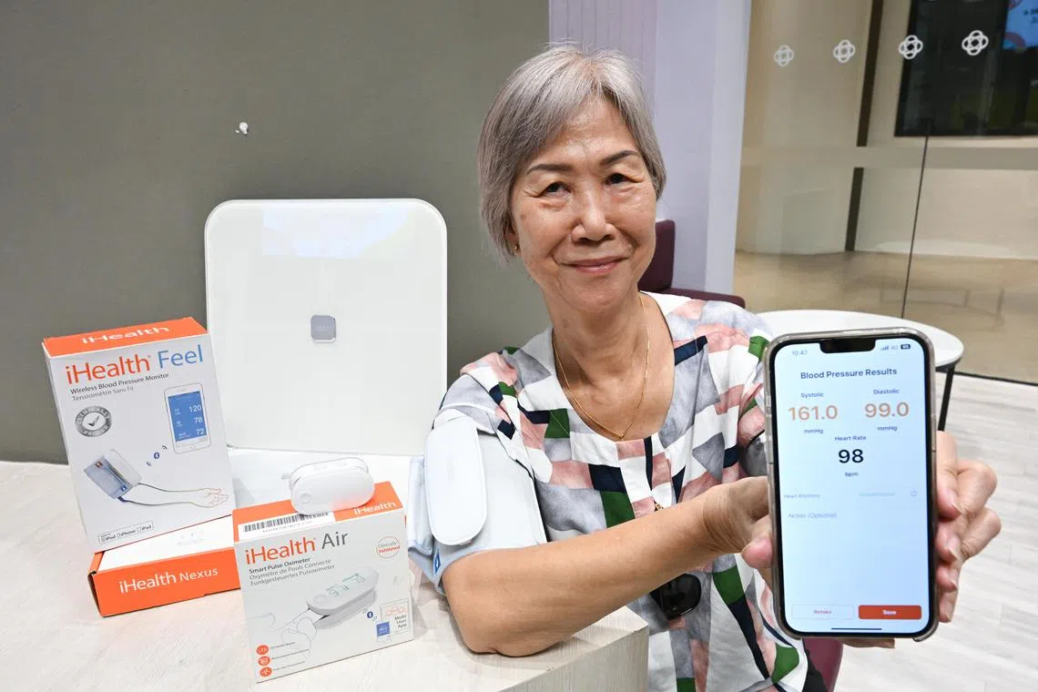 ST20240921-202482200622-Lim Yaohui-Ahmad Zhaki Bin Abdullah-azcare21/
Madam Yong Yoke Kwai, 74, Housewife, demonstrating the use of Wireless Blood Pressure Monitor used with the HealthBeats app for Remote Monitoring & Support Programme for Seniors, together with the Wireless Body Composition Scale and Smart Pulse Oximeter beside her, during Caregiving Fest, the culmination of Caregiving Week 2024, at Sengkang Grand Mall on Sept 21, 2024.
Ms Sim Ann, Senior Minister of State in the Ministry of Foreign Affairs and the Ministry of National Development, and Grassroots Adviser in Holland-Bukit Timah GRC, is the Guest-of-Honour.
The Caregiving Welfare Association (CWA), in collaboration with SG Assist and The Compassionate Network, is organising Caregiving Week 2024, from Sept 16 to Sept 21, 2024.
Caregiving Welfare Association is introducing the Remote Monitoring & Support Programme for Seniors, which is using technology to introduce solutions to enable vulnerable seniors to measure their vitals and monitor those at higher risk of falls.
(ST PHOTO: LIM YAOHUI)