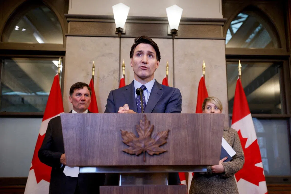 FILE PHOTO: Canada's Prime Minister Justin Trudeau, with Minister of Foreign Affairs Melanie Joly, and Minister of Public Safety, Democratic Institutions and Intergovernmental Affairs Dominic LeBlanc, takes part in a press conference about the Royal Canadian Mounted Police's investigation into \"violent criminal activity in Canada with connections to India\", on Parliament Hill in Ottawa, Ontario, Canada October 14, 2024. REUTERS/Blair Gable//File Photo