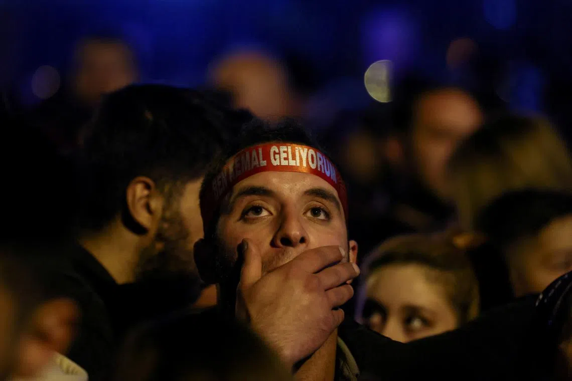 A supporter of Kemal Kilicdaroglu reacts as voters await election results in Ankara. 