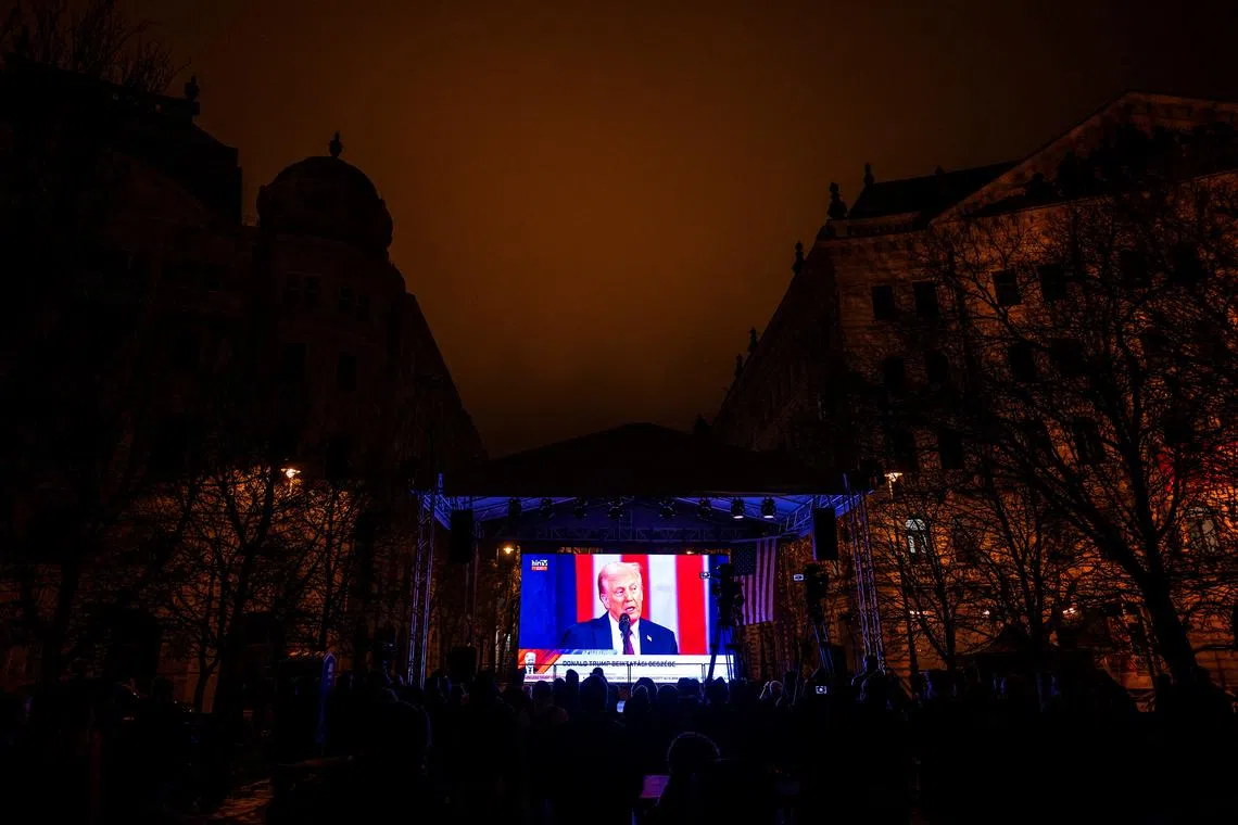 FILE PHOTO: U.S. President Donald Trump is seen on a screen during his speech at an inauguration party held in Budapest outside the U.S. embassy in Budapest, Hungary January 20, 2025. REUTERS/Marton Monus/File Photo