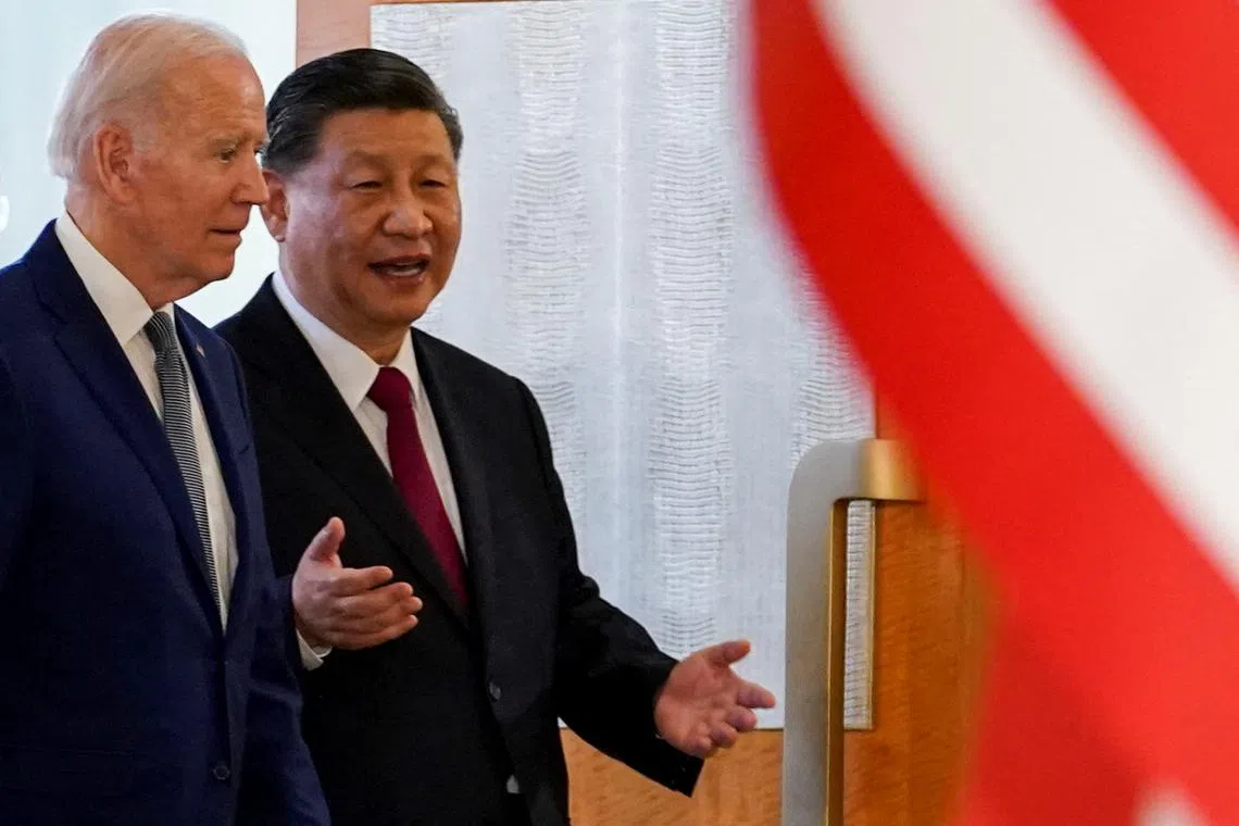 US President Joe Biden (left) speaking with Chinese President Xi Jinping on the sidelines of the G-20 summit in Bali on Nov 14, 2022.