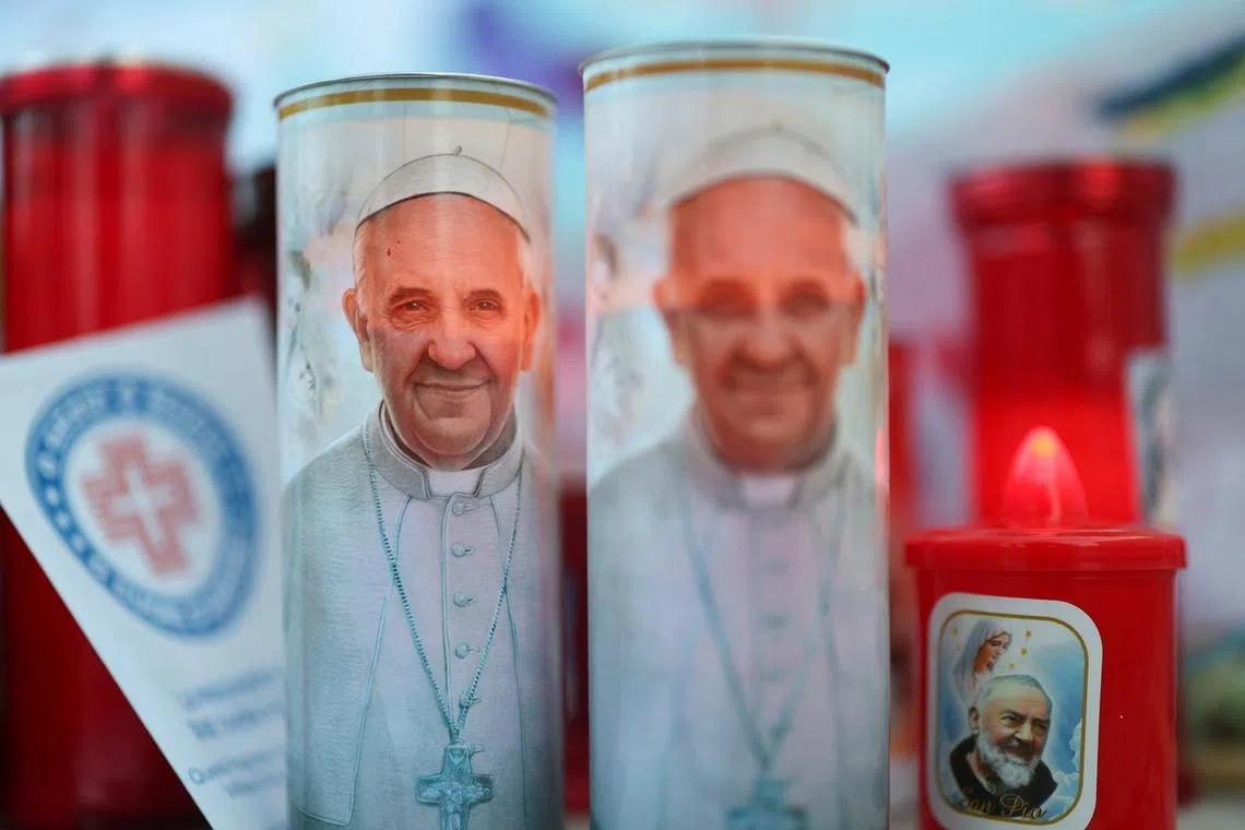 Images of Pope Francis placed outside the Gemelli Hospital in Rome, where the pontiff is admitted for treatment, on Feb 28.