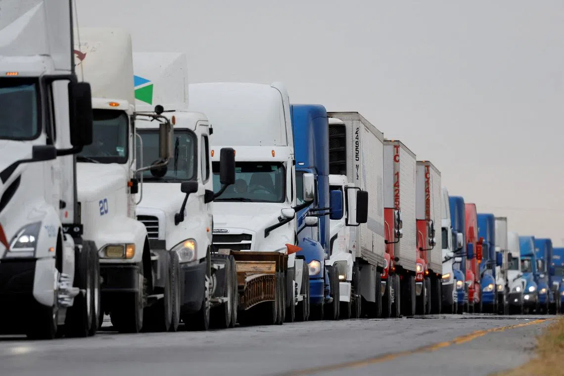 FILE PHOTO: Trucks wait in line to cross into the United States near the border customs control at the World Trade Bridge, in Nuevo Laredo, Mexico, November 26, 2024. REUTERS/Daniel Becerril/File Photo