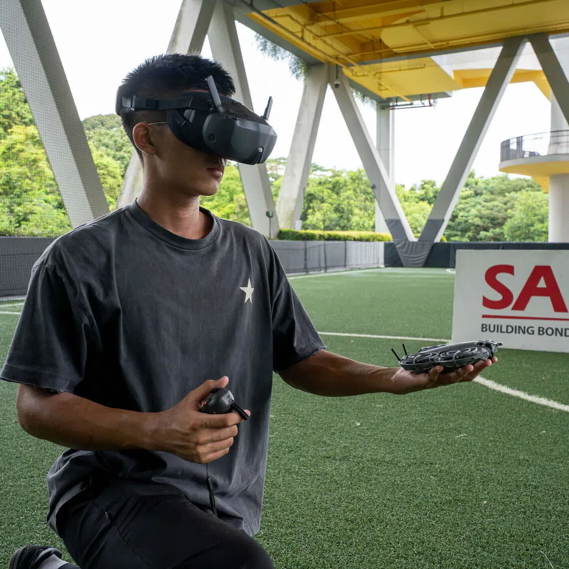 An NSman testing a drone at SAFRA Choa Chu Kang.