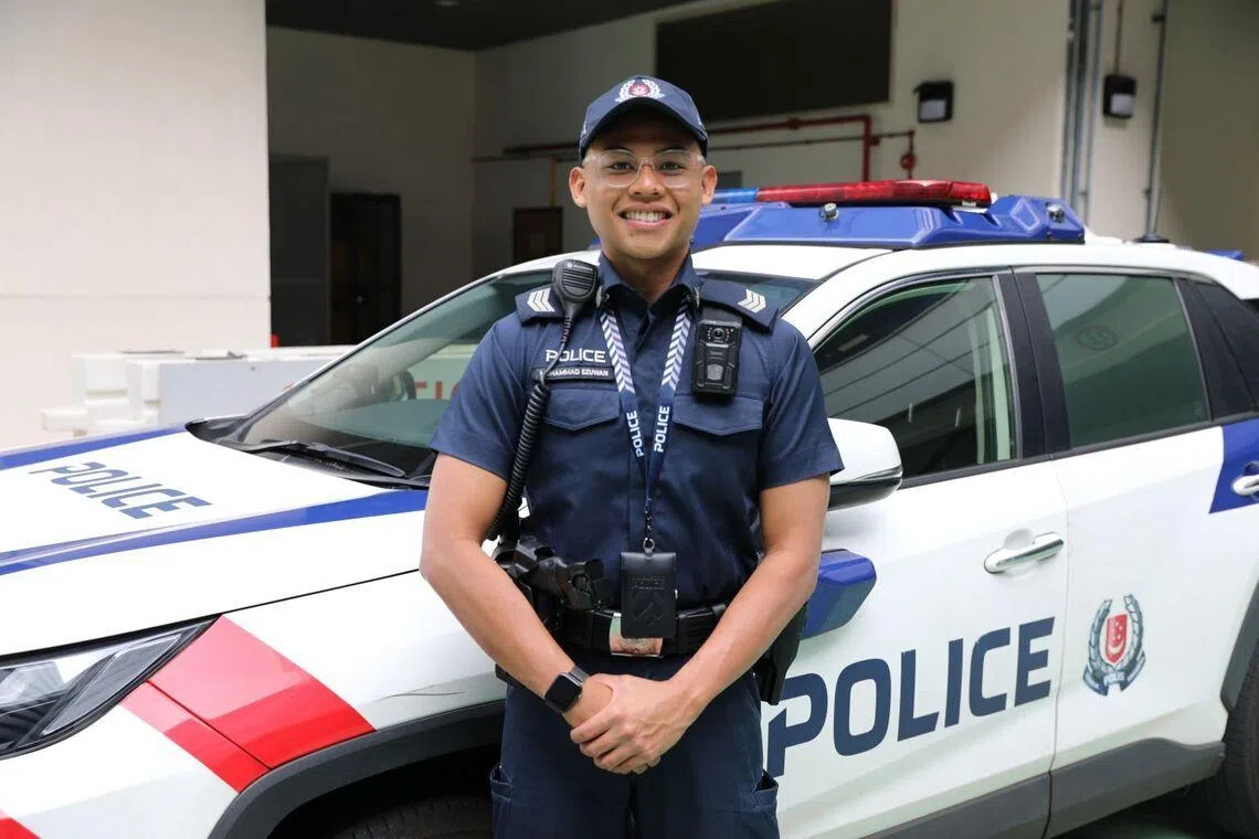 Muhammad Ezuwan standing in front of a police car.