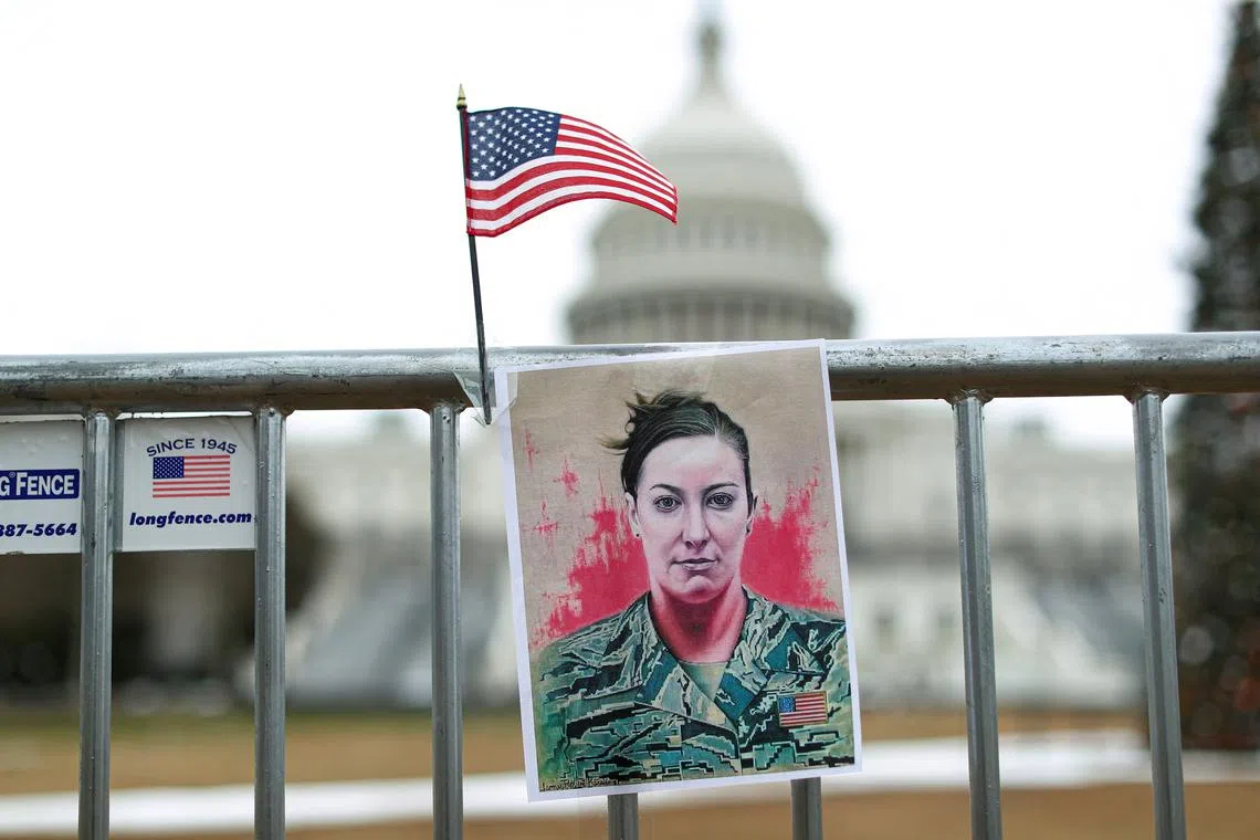 FILE PHOTO: A portrait of Ashli Babbitt who was shot dead during the January 6, 2021 attack on the U.S. Capitol, hangs on a fence on the first anniversary of the event outside the Capitol, in Washington, D.C., U.S., January 6, 2022. REUTERS/Tom Brenner/File Photo