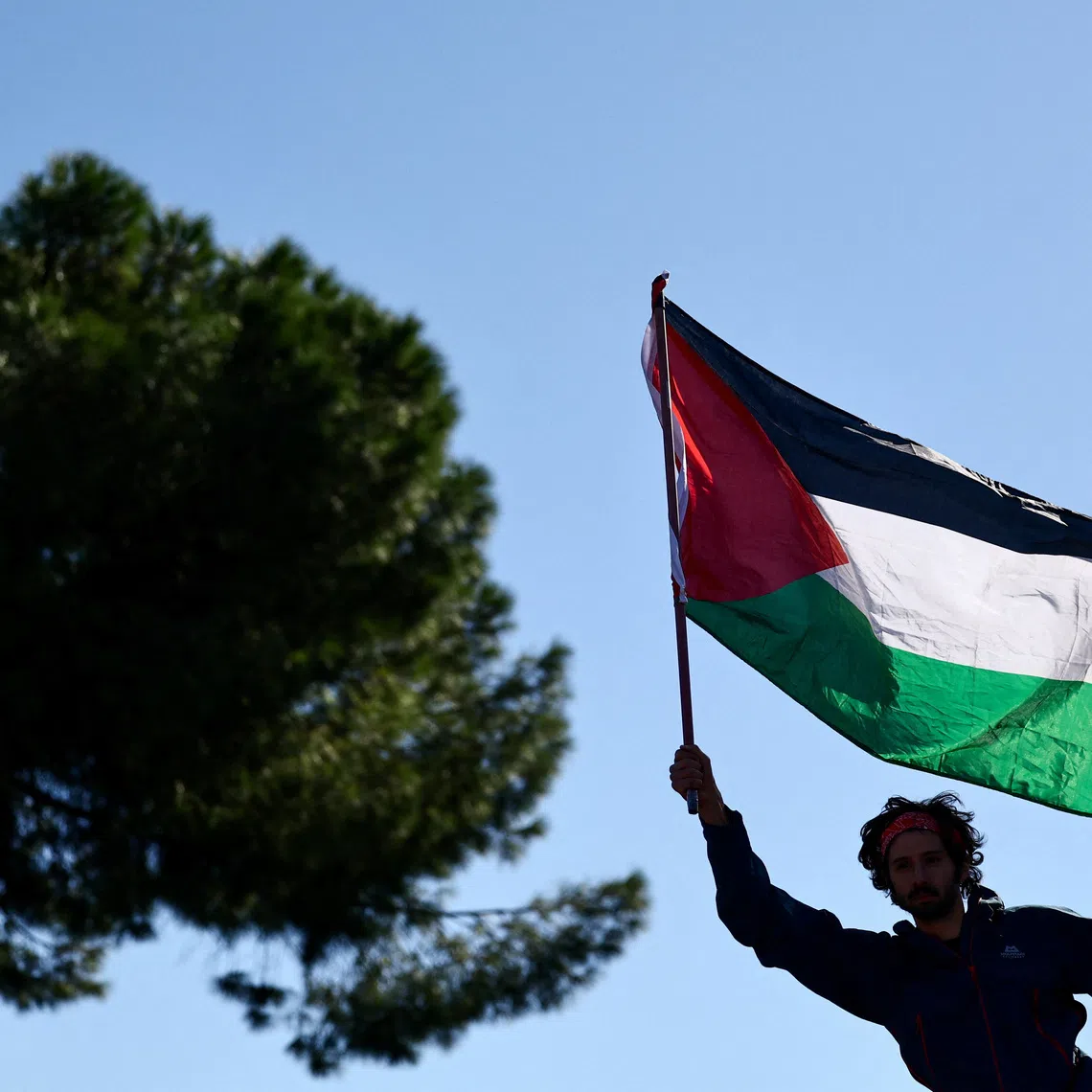 A pro-Palestinian demonstrator attends a protest during a nationwide strike called by the USB union to condemn the Israeli forces' interception of the vessels of the Global Sumud Flotilla aiming to reach Gaza and break Israel's naval blockade, in Rome, Italy, October 3, 2025. REUTERS/Yara Nardi