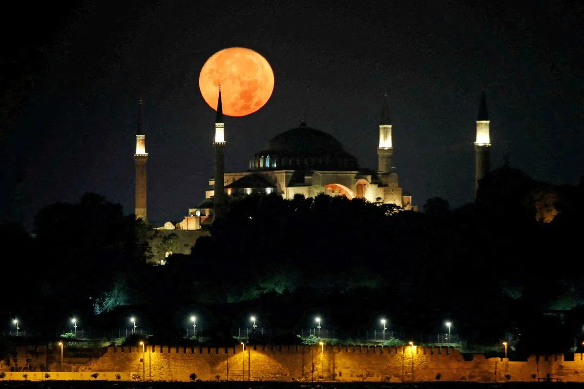 A blue supermoon is pictured over the Hagia Sophia Grand Mosque in Istanbul, Turkey, on Aug 30, 2023. 