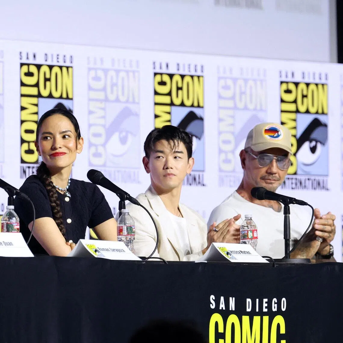 The voice cast includes Roman Zaragoza (left) as Sokka, Jessica Matten as Katara, Eric Nam as Aang and Dave Bautista (right) as the villain Tagah.