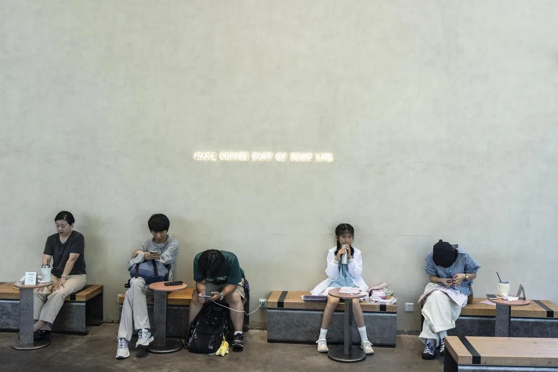 FILE Ñ People at a cafe in the township of Liangzhu, China, June 27, 2025. As Beijing pushes consumer lending to stimulate the economy, millions of Chinese borrowers, especially the young, are falling into debt spirals. (Qilai Shen/The New York Times)