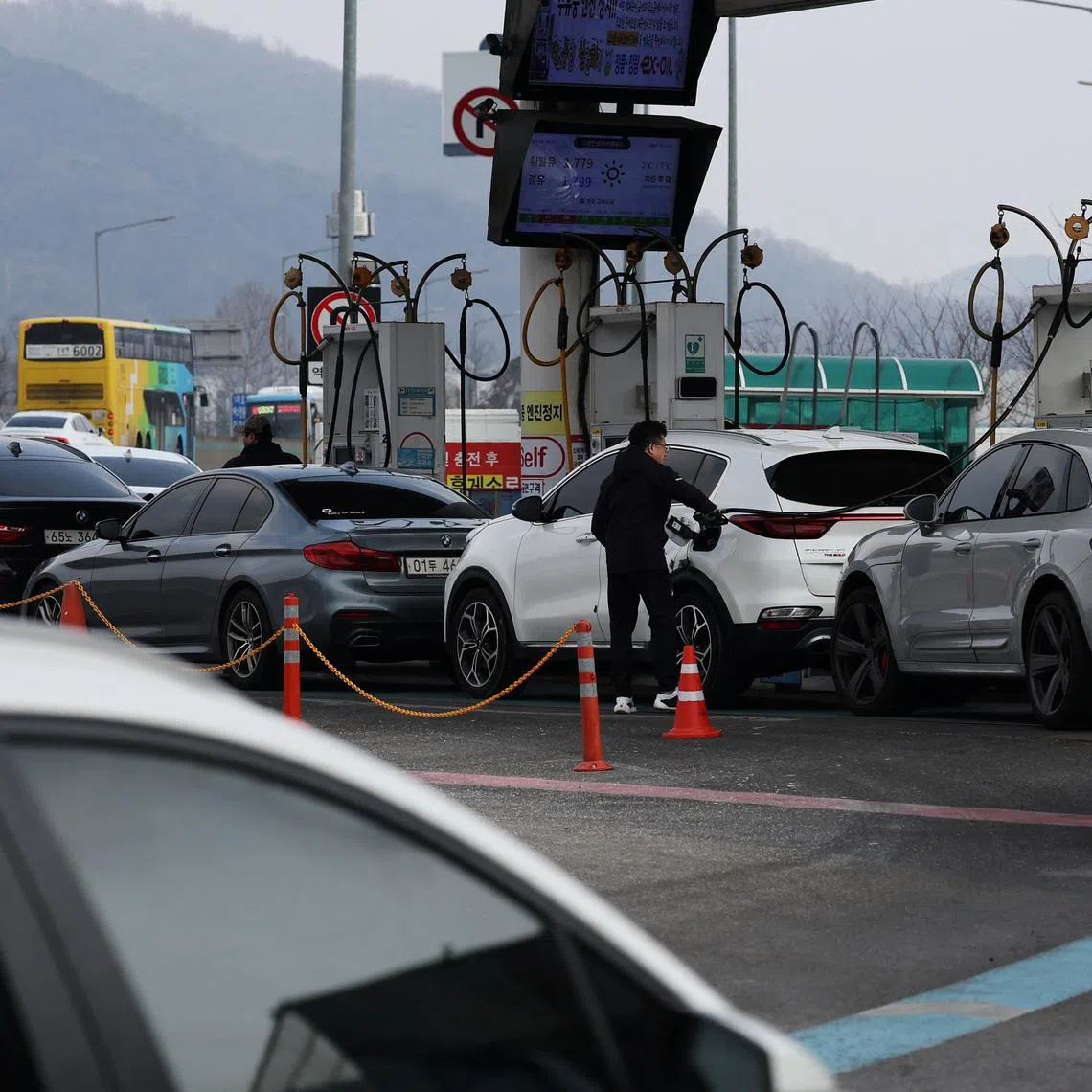 A man fills up his car at a gas station in Seoul, South Korea, March 9, 2026.   REUTERS/Kim Hong-Ji