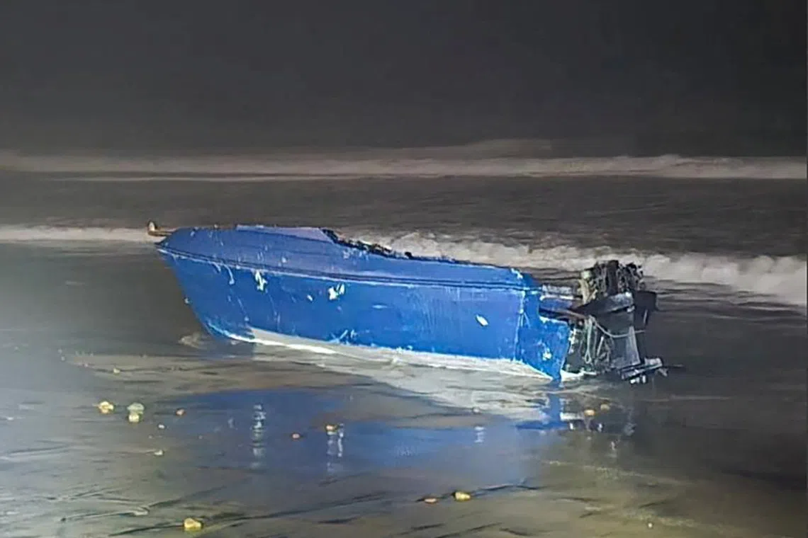 A vessel which capsized off the coast, prompting a search for its missing occupants, lies on a beach in Imperial Beach, California, U.S., November 14, 2025.  U.S. Coast Guard/Handout via REUTERS