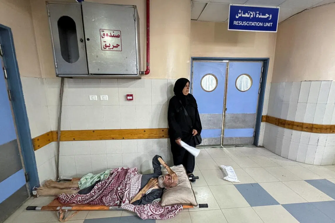 A wounded Palestinian man, who was evacuated from the European Hospital, lies on a stretcher on the floor at Nasser Hospital, in Khan Younis in the southern Gaza Strip on July 2, 2024. 