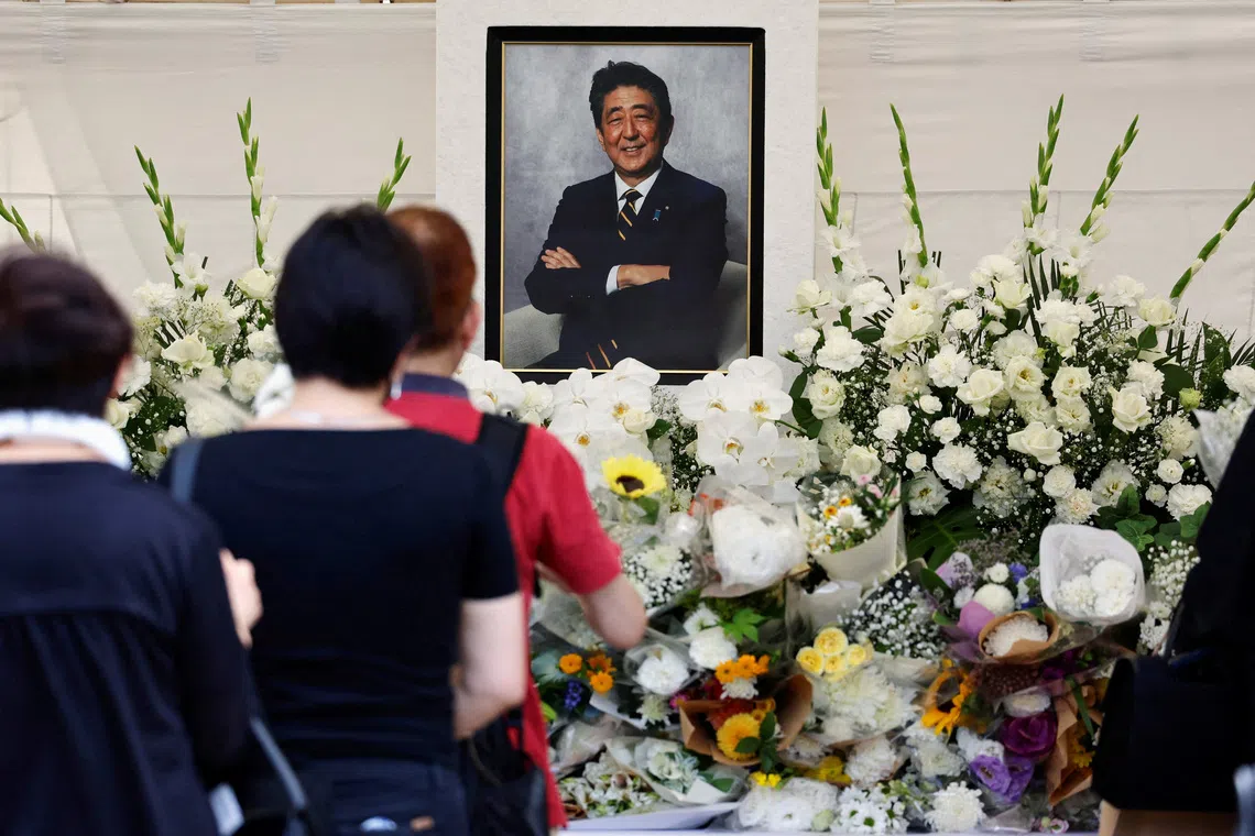 FILE PHOTO: Mourners offer flowers and prayers for the late Japanese Prime Minister Shinzo Abe, who was shot while campaigning for a parliamentary election in 2022, during the one year commemoration ceremony of his assassination at Zojoji temple in Tokyo, Japan July 8, 2023. REUTERS/Issei Kato/File Photo