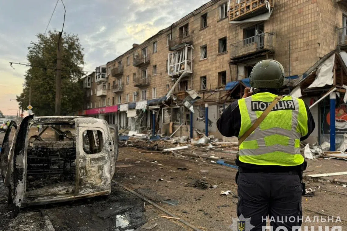 A police officer takes a picture of a residential building damaged during a Russian drone strike, amid Russia's attack on Ukraine, in the town of Konotop, Sumy region, Ukraine September 12, 2024. Press service of the National Police of Ukraine in Sumy region/Handout via REUTERS ATTENTION EDITORS - THIS IMAGE HAS BEEN SUPPLIED BY A THIRD PARTY. DO NOT OBSCURE LOGO.