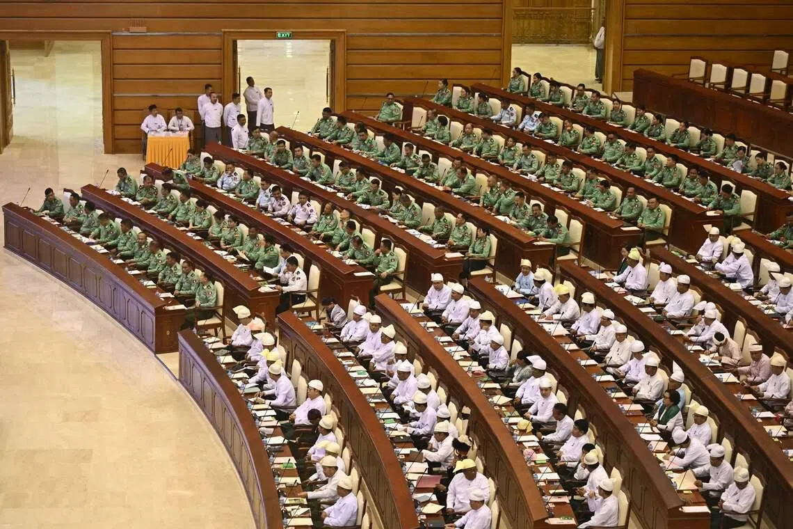 Members of Myanmar's parliament attend a session of the third term of the Pyithu Hluttaw (House of Representatives) on March 16.