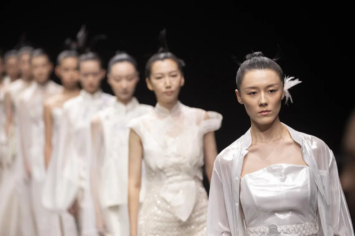 Models presenting creations of Suncun by Yan Zhang on Sept 10.