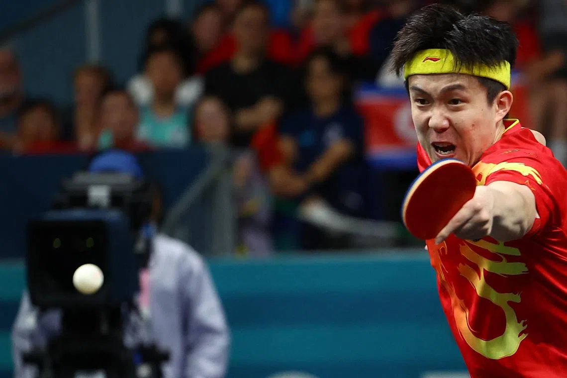 Paris 2024 Olympics - Table Tennis - Mixed Doubles Gold Medal Match - South Paris Arena 4, Paris, France - July 30, 2024. Chuqin Wang of China in action during their match with Yingsha Sun of China against Jong Sik Ri of North Korea and Kum Yong Kim of North Korea. REUTERS/Kim Hong-Ji