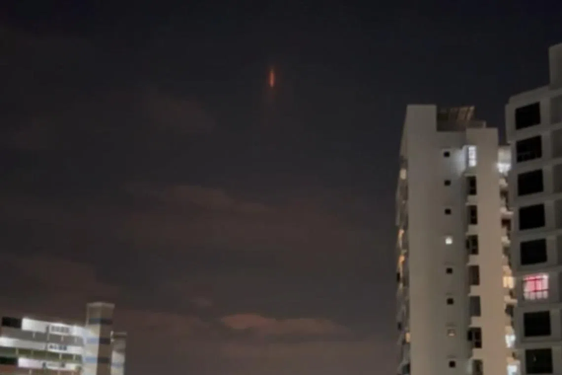An orange vertical line in the night sky in Yishun on Dec 10.