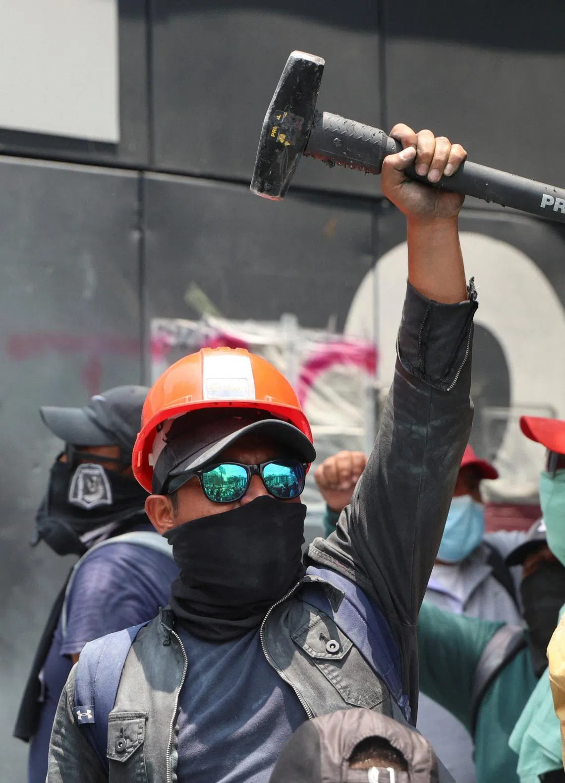 A dissident teacher from Mexico’s National Coordination of Education Workers holding a sledgehammer during the protest.
