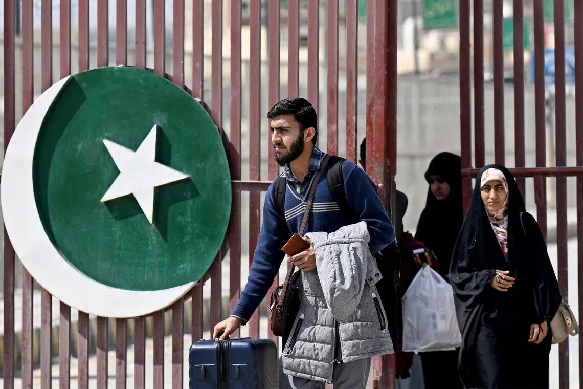 Pakistani nationals returning by land from Iran arrive in Taftan, in Balochistan province, on March 5.