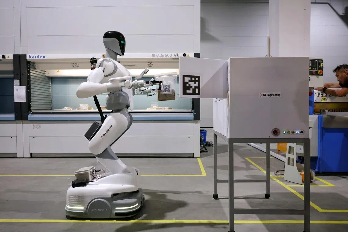 The robots are part of an automated system that transports aircraft parts, tools and materials from storage to the hangar floor.