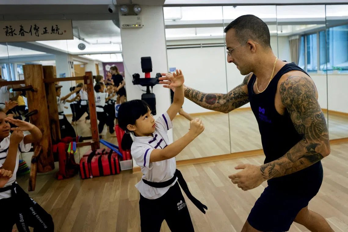 Nima King, 38, teaching Amber, 7, the principles of Wing Chun at the Mindful Wing Chun School on June 18. Some Wing Chun enthusiasts, such as Iranian-Australian King, have sought to modernise the teaching style. 