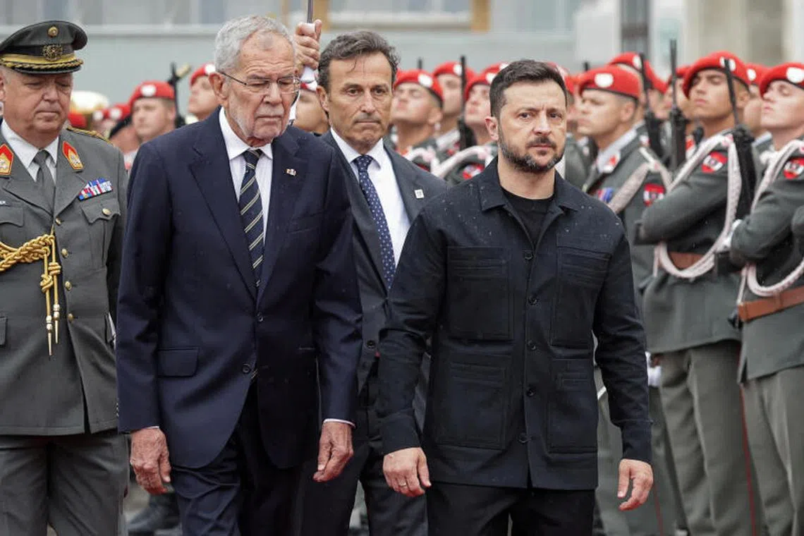 Austrian President Alexander Van der Bellen (left) and Ukrainian President Volodymyr Zelensky review the Guard of Honour, in Vienna, Austria, on June 16.