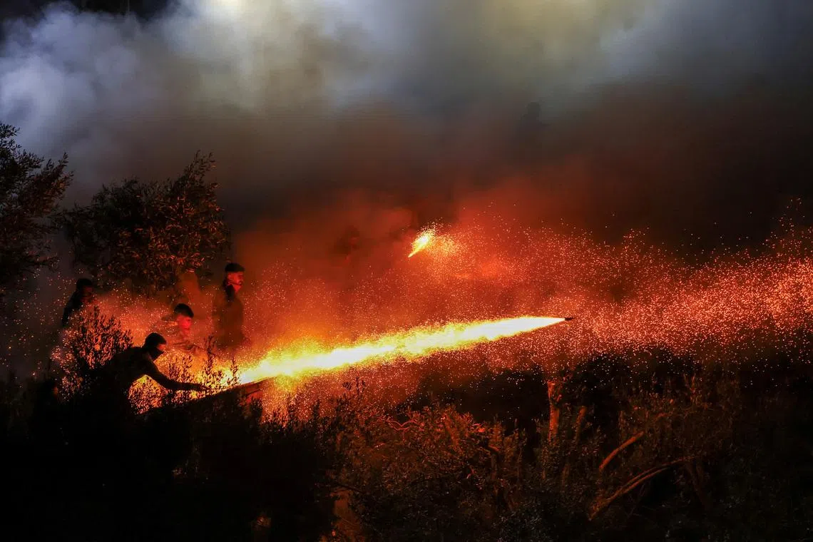 People igniting handmade rockets during Greek Orthodox Easter celebrations in the village of Vrontados, on the island of Chios, Greece, April 11, 2026. 
