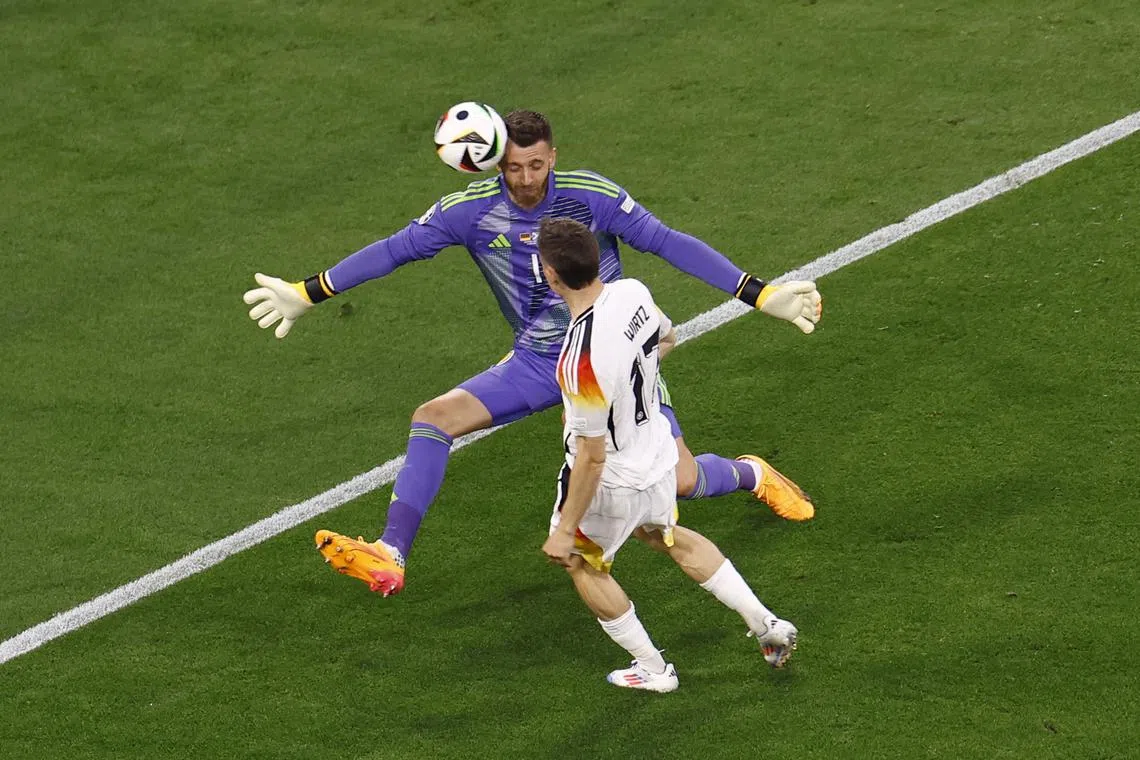 FILE PHOTO: Soccer Football - Euro 2024 - Group A - Germany v Scotland - Munich Football Arena, Munich, Germany - June 14, 2024  Germany's Florian Wirtz shoots at goal as Scotland's Angus Gunn makes a save with his head REUTERS/Michaela Stache