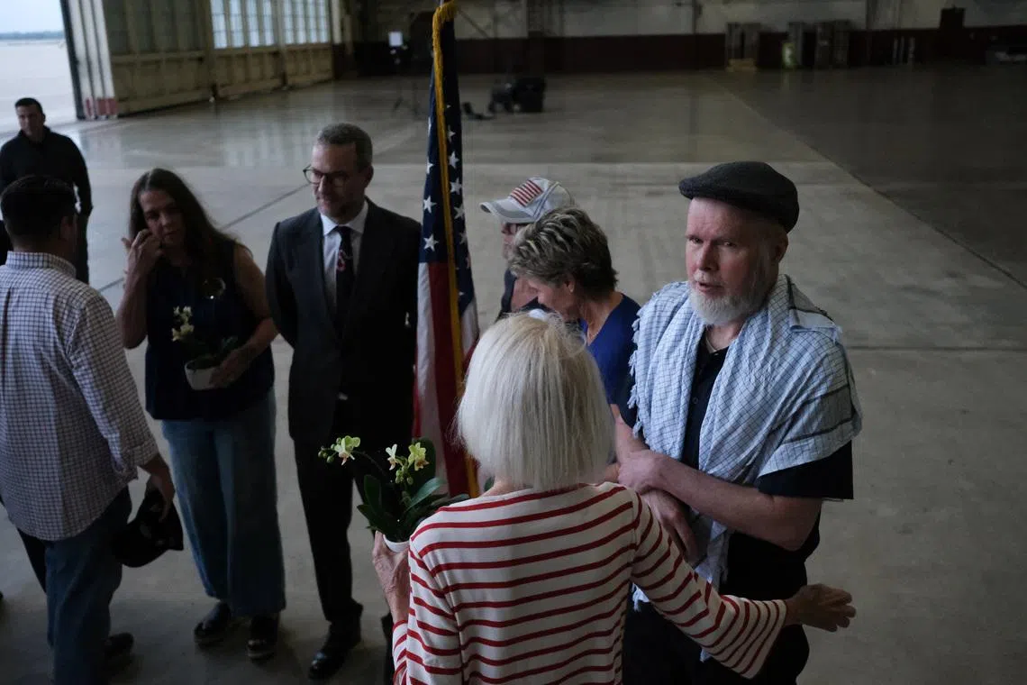 American Dennis Coyle, who was detained by the Afghan Taliban government for more than year, is greeted as he arrives at Joint Base San Antonio in San Antonio, Texas, U.S., March 25, 2026. REUTERS/Joel Angel Juarez