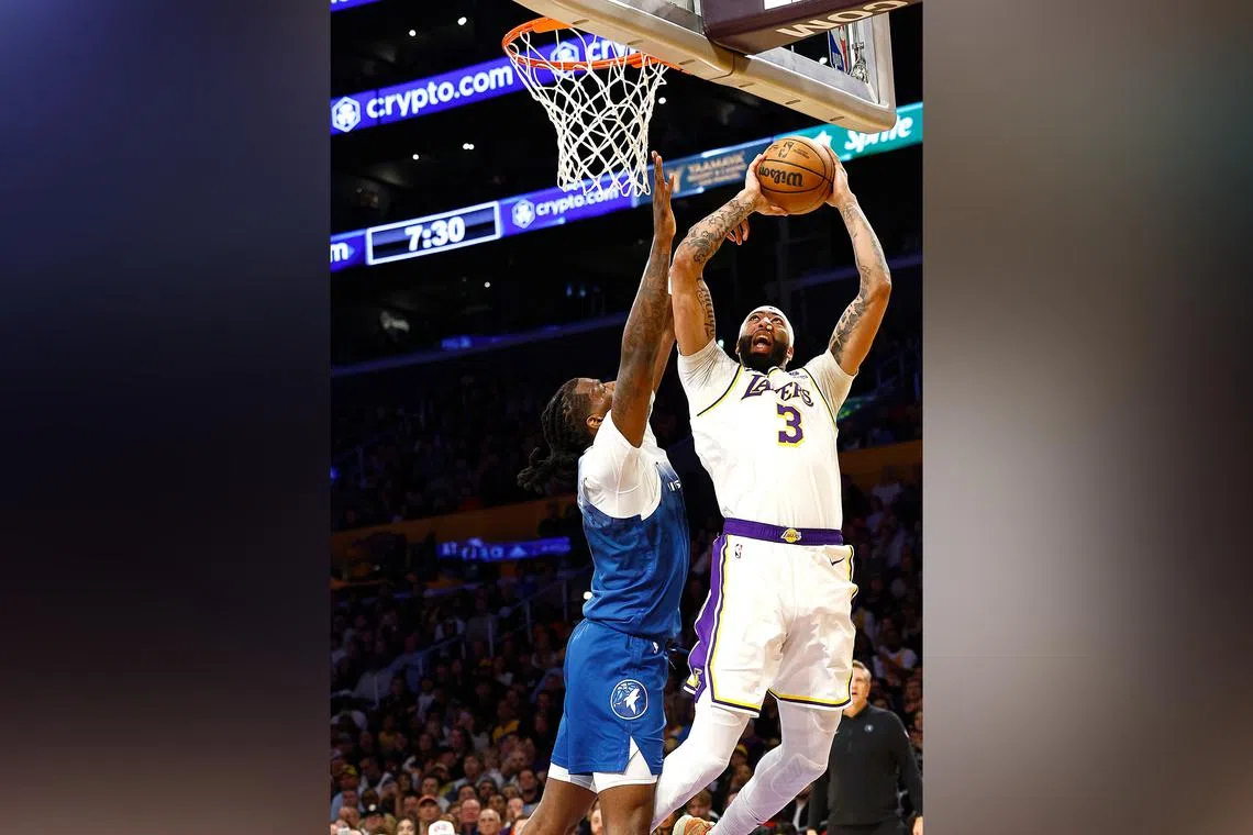 Anthony Davis of the Los Angeles Lakers being fouled by Naz Reid of the Minnesota Timberwolves in the first half on March 10.