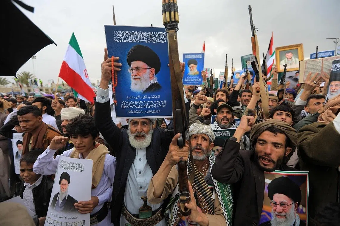 Houthi supporters brandishing rifles and holding portraits of Iran’s slain supreme leader Ayatollah Ali Khamenei during a rally in the Yemeni capital Sana’a on March 6. 