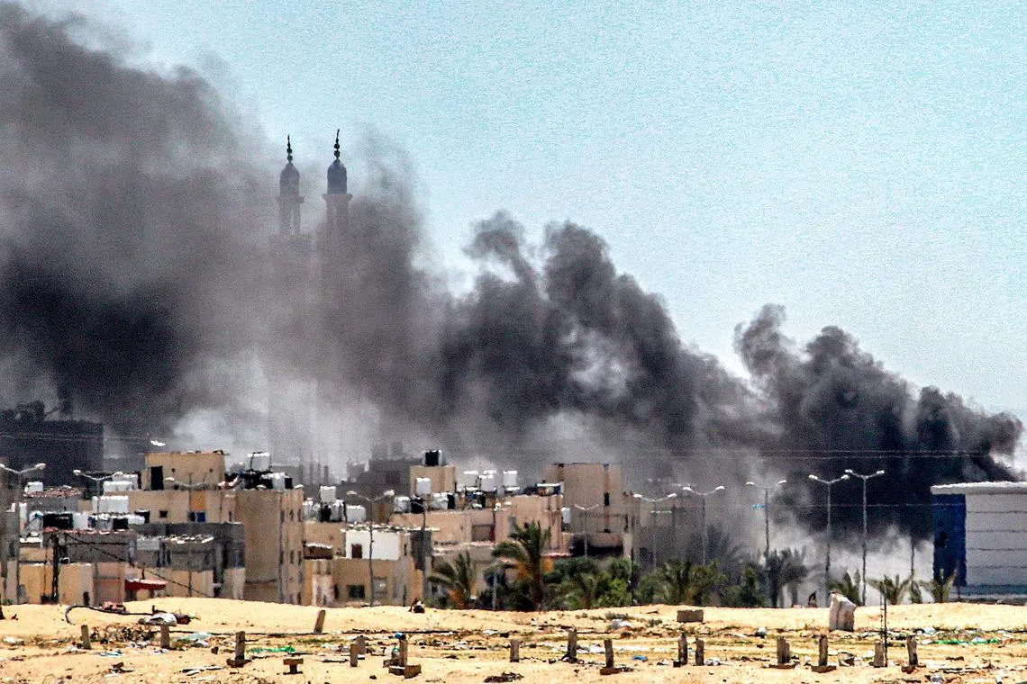 Smoke plumes billow during ongoing battles in the Sultan neighbourhood in the northwest of Rafah on June 18.