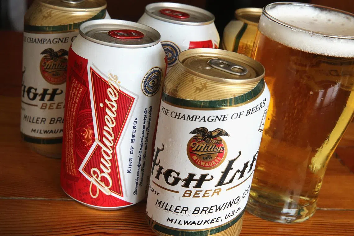 CHICAGO, IL - SEPTEMBER 15: In this photo illustration, cans of Miller High Life and Budweiser beer that are products of SABMiller and Anheuser-Busch InBev (respectively) are shown on September 15, 2014 in Chicago. Illinois. Shares of SABMiller have surged to an all-time high today on speculation of a takeover bid by Anheuser-Busch InBev, the world's largest brewer. (Photo Illustration by Scott Olson/Getty Images/AFP (Photo by SCOTT OLSON / GETTY IMAGES NORTH AMERICA / Getty Images via AFP)