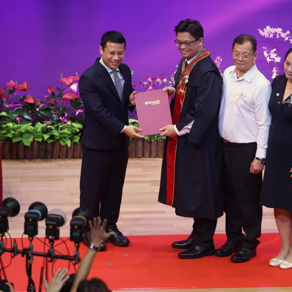 Temasek Polytechnic student Justin How Wei Inn receiving his diploma and the Lee Kwan Yew Award from Minister of Education Desmond Lee during the Temasek Polytechnic Graduation Ceremony on May 8, 2026.