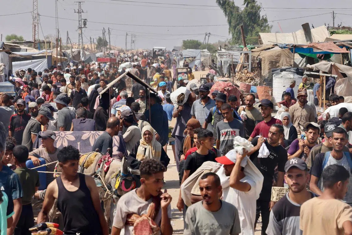 Palestinians carrying humanitarian supplies in Rafah in the southern Gaza Strip on July 30. 