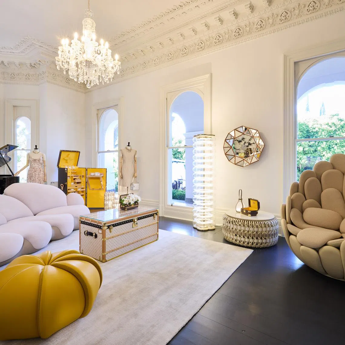 A luxury home setting in Melbourne of Louis Vuitton pieces including a Louis Vuitton trunk used as a coffee table, and travel-inspired furniture and objects from the Objets Nomades collection. 