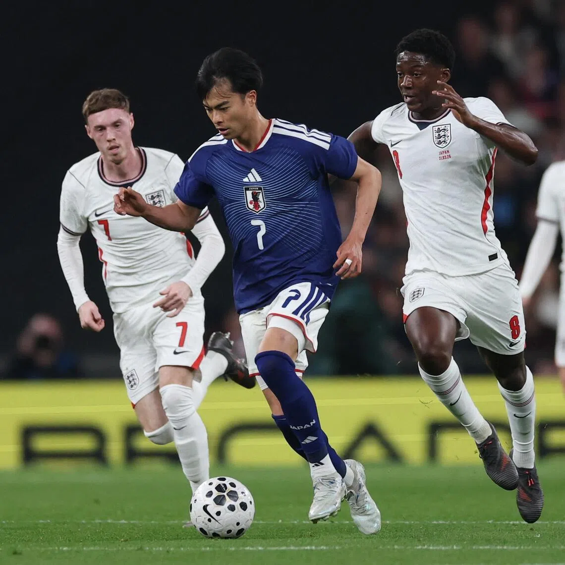 Kaoru Mitoma trying to evade the attentions of England's Kobbie Mainoo (right) and Cole Palmer during the 1-0 friendly win over England at Wembley on March 31, 2026, in London.