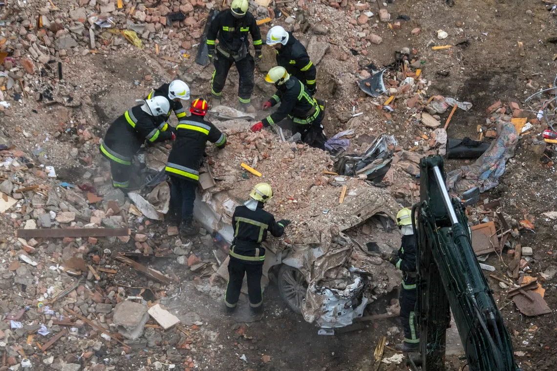 Ukrainian rescuers working at the site of a Russian strike on a high-rise residential building in Ternopil, western Ukraine, on Nov 21.