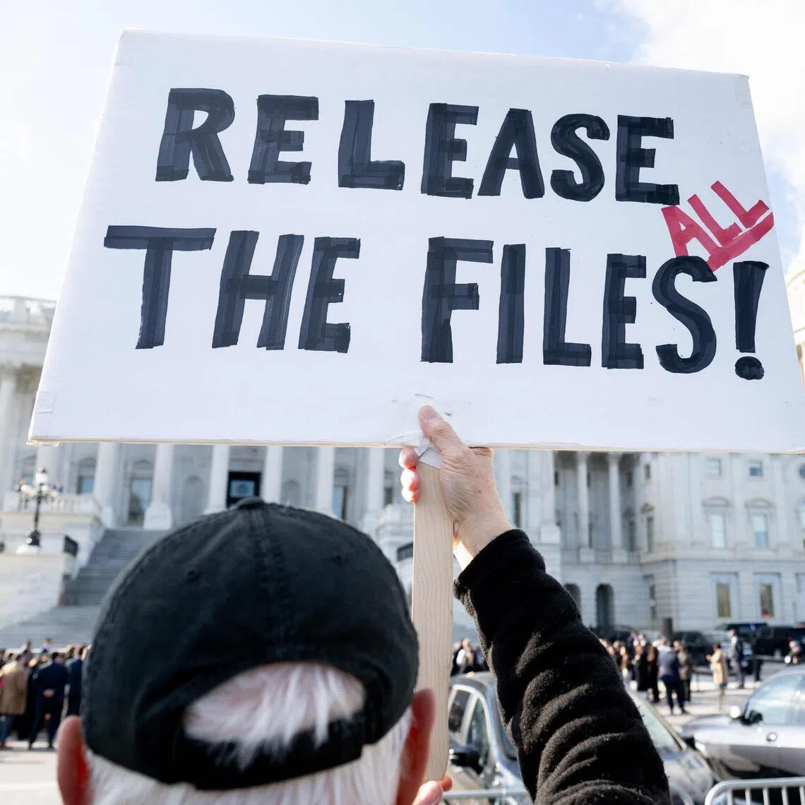A protester holds a sign related to the release of the Jeffrey Epstein case files outside the US Capitol in Washington, DC, Nov 12, 2025. PHOTO: AFP